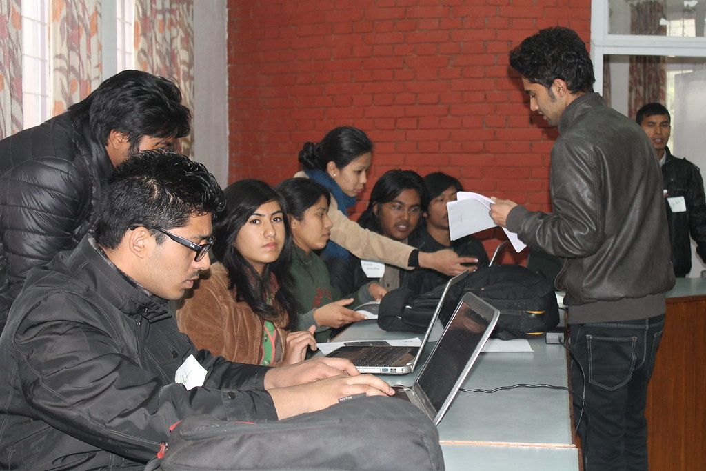 A team working on laptops during a mapping session in Kathmandu